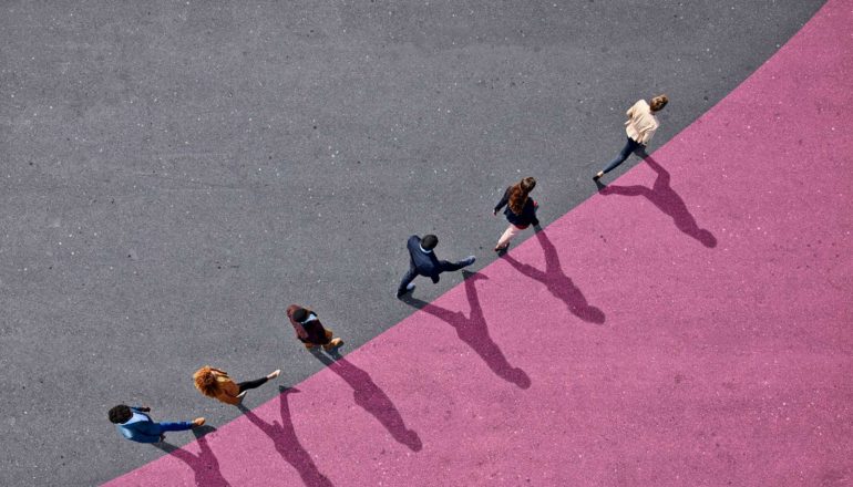 line of people walk along upward-curving line