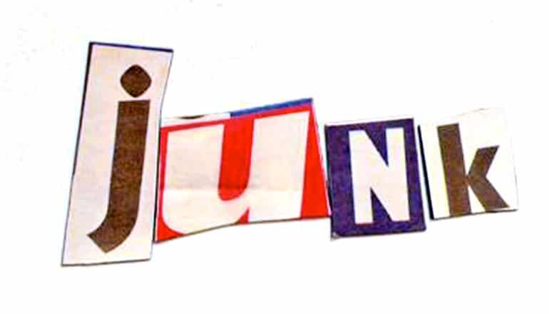 Letters cut out of a magazine spell "Junk" on a white background