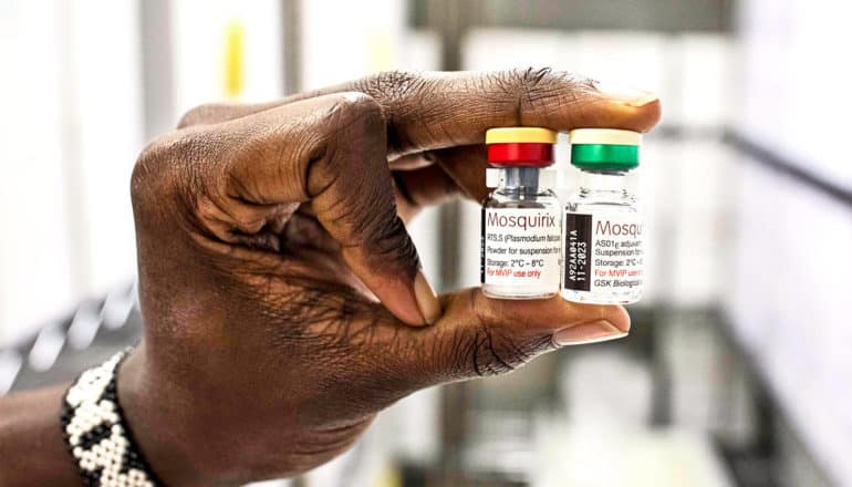 A person holds two vials of the new malaria vaccine