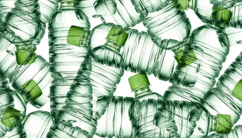 Many green plastic bottles piles on a white background