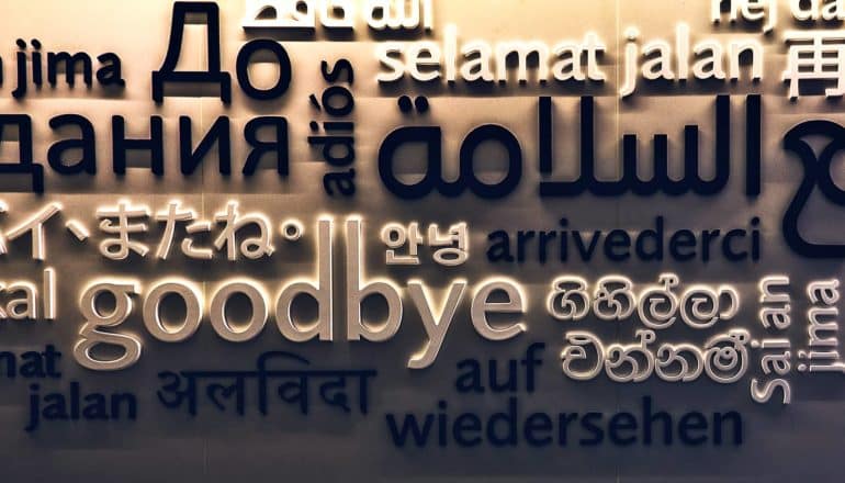 A wall has the word "goodbye" in many different languages