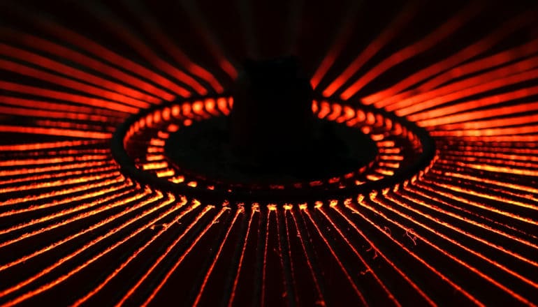 A stove burner looks like a black hole at the center of glowing red lines