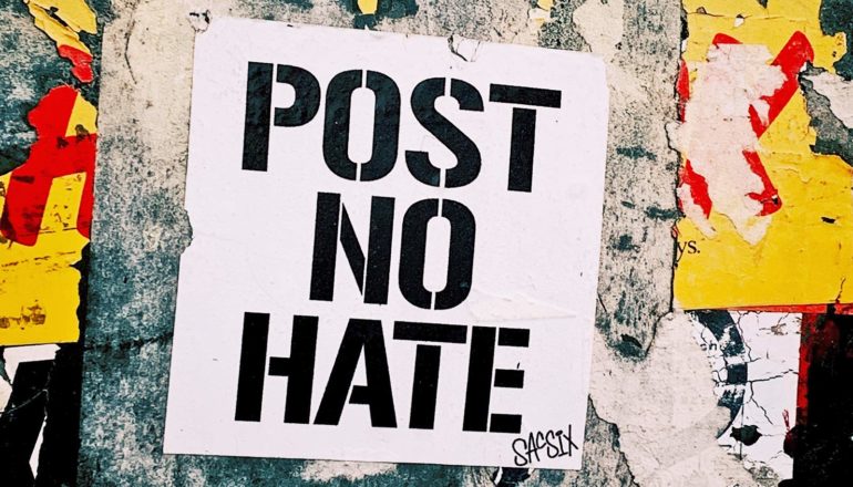 sign says "post no hate"