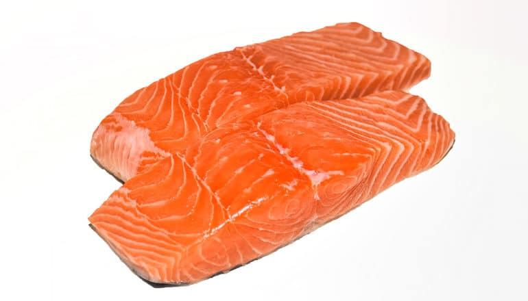 Pink pieces of salmon on a white background