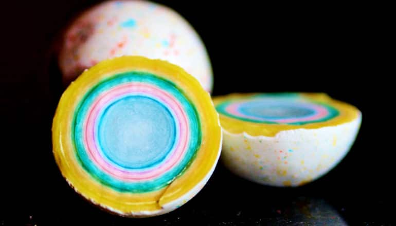 A jawbreaker cut in half reveals a brightly colored core