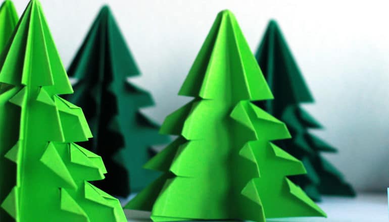 Small paper trees sit on a white background