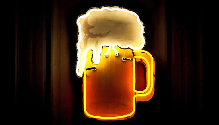 A neon sign shows a mug of beer with overflowing froth