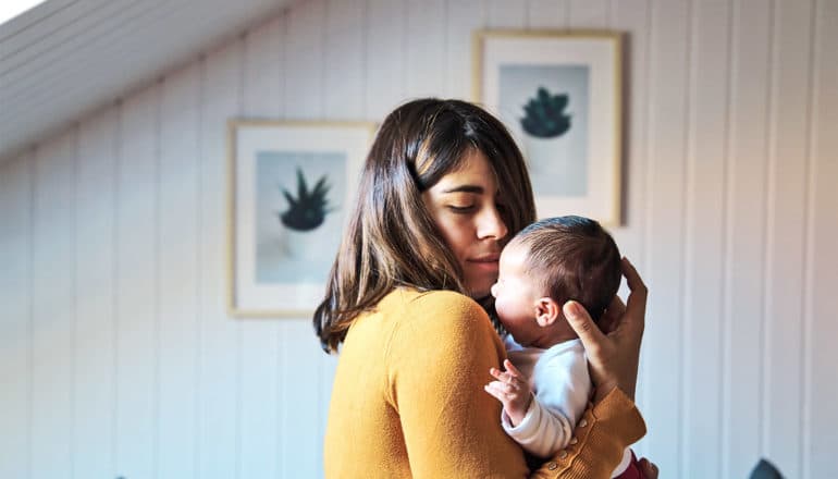 A mother holds her newborn baby