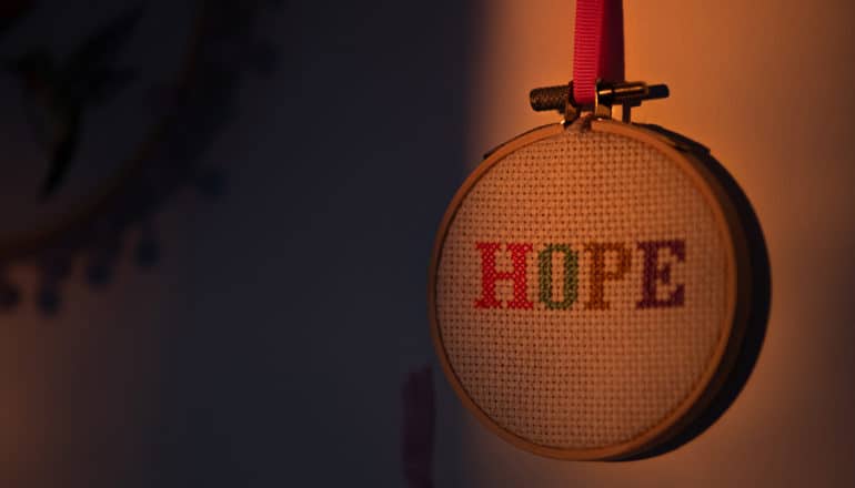 "hope" needlepoint in gloomy light