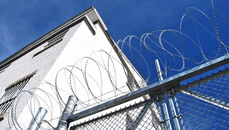 razor wire on gate in front of building