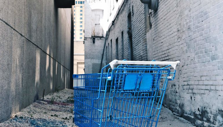 blue shopping cart in alley