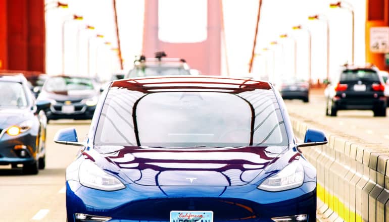 A Tesla drives across the Golden Gate Bridge in San Francisco