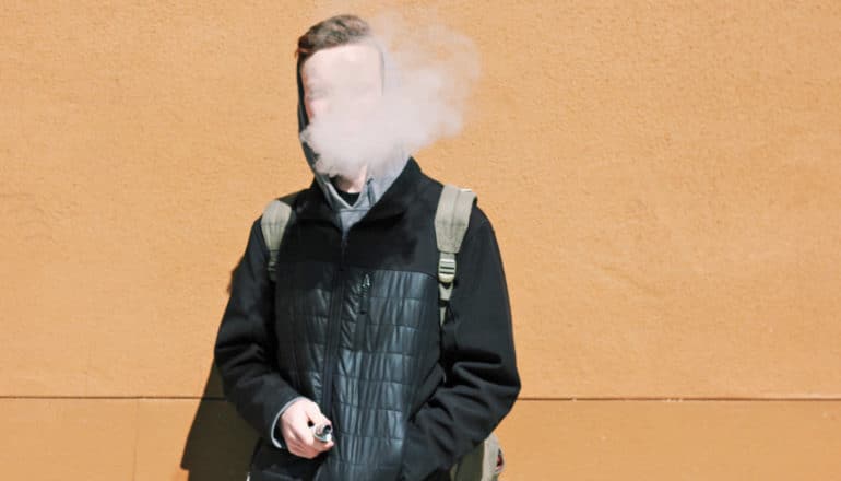 person in coat, backpack vapes