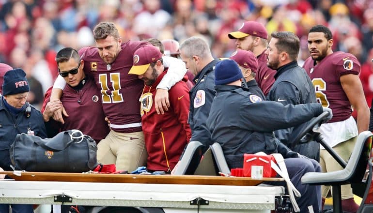 injured football player gets help boarding cart