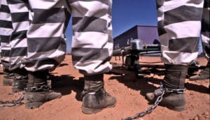 uniformed prisoners chained at ankles