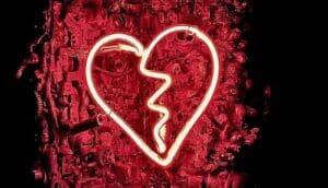 A neon sign in the shape of a broken heart.