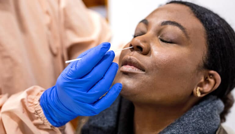 A woman gets a nasal swab covid-19 test.