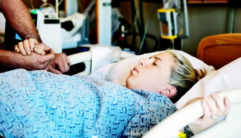 A woman in a hospital bed having a contraction.