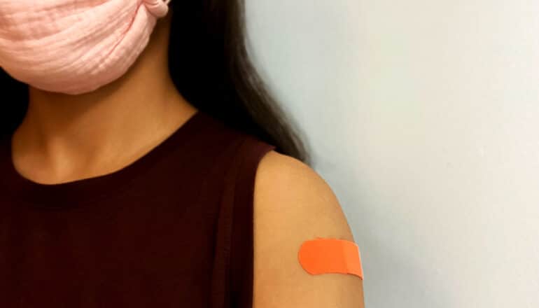 bandaid on masked person's arm