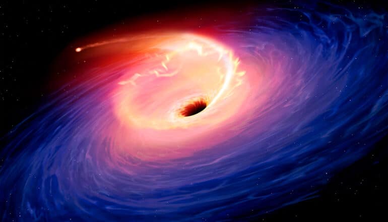 A black hole consuming a star in space.