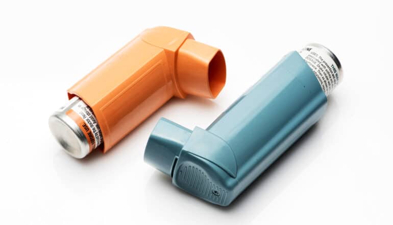 orange and teal inhalers on white