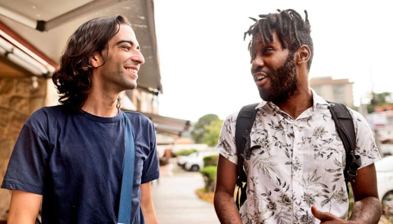 friends smile and talk while walking