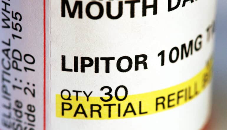 pill bottle label says "Lipitor 10 MG QTY 30 partial refill"