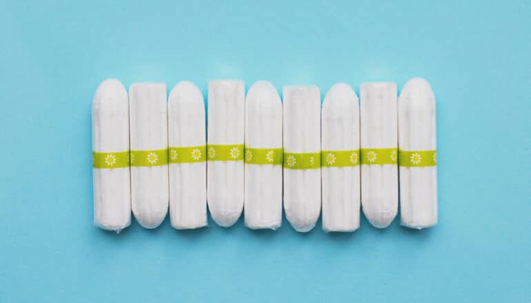 row of tampons on blue background