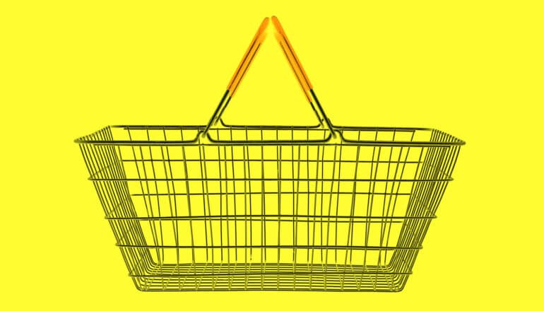 empty shopping basket on bright yellow background