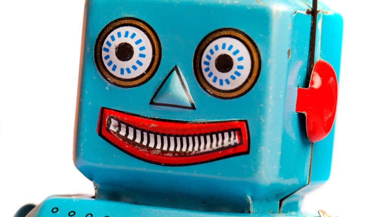 A blue robot toy with a smiling face.