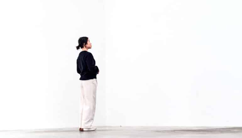 person stands in empty white room