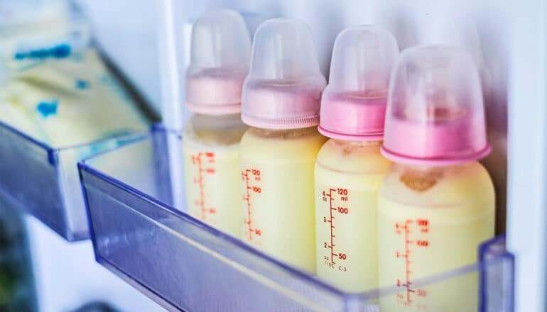 Bottles of breast milk in a refrigerator.