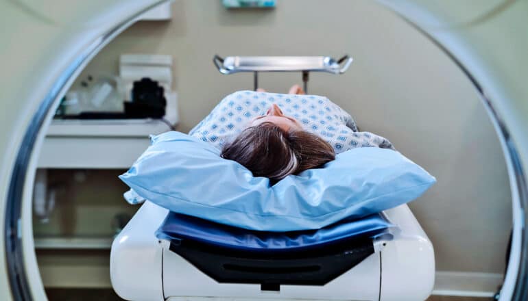 A person laying down ready for a CT scan.