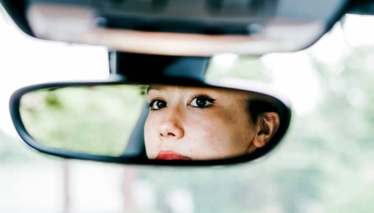 serious face in car's rearview mirror