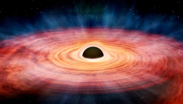 Swirling red gas around a black hole.