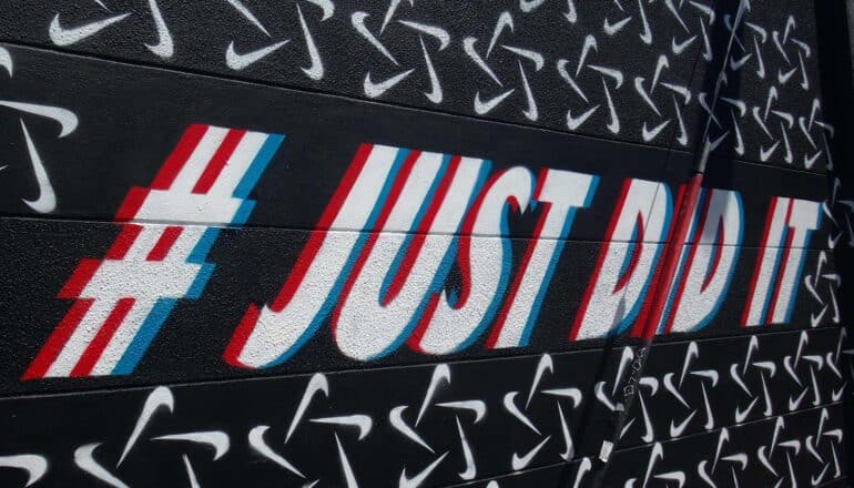 mural says "# just did it" on black wall