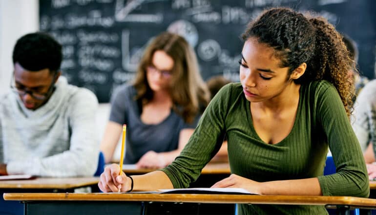 Students take a test in a classroom.