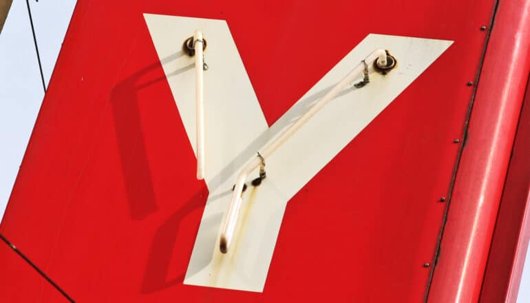 A white letter Y on the red surface of a sign.