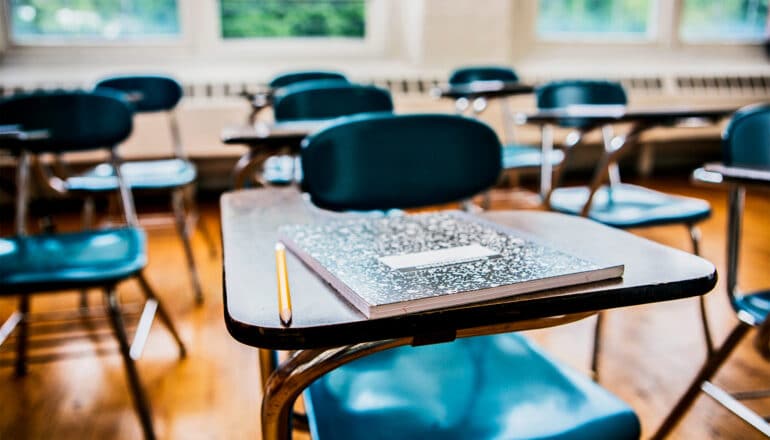 Classroom desks without any students sitting in them.