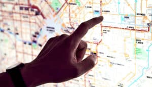 A person points at a subway map.