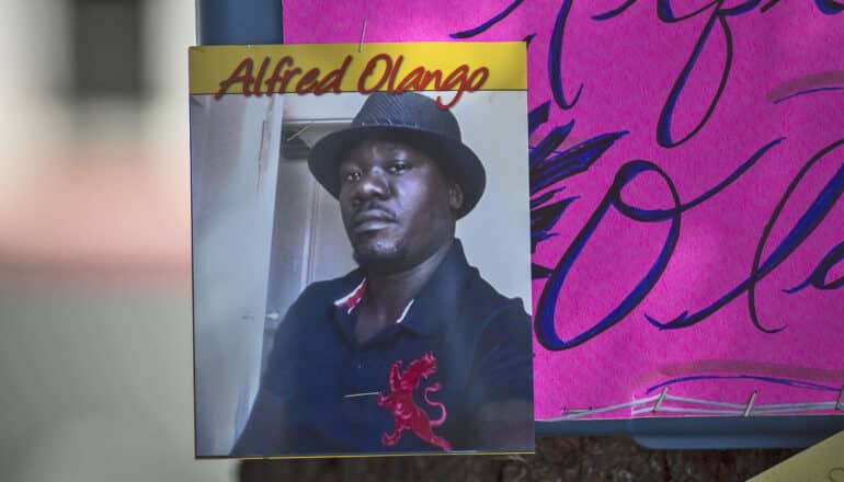 photo of Alfred Olango attached to pink protest sign