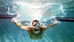 A man in a pool after a belly flop.