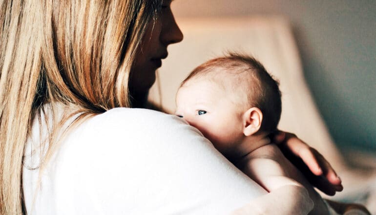 A mother holds her baby.