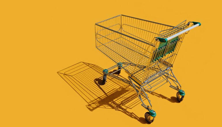 An empty shopping cart on a yellow background.