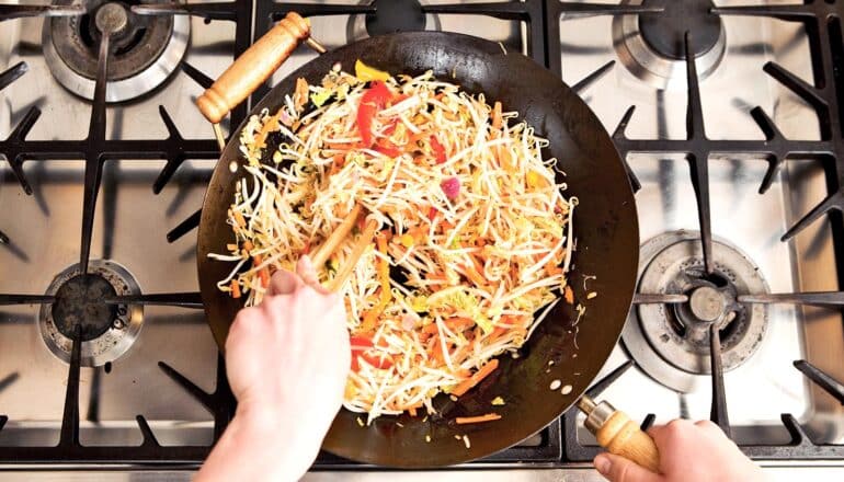 high angle view of stir-frying vegetables in pan on stove