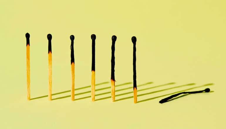 A row of increasingly burnt matches, with the last completely burnt and laying on its side.