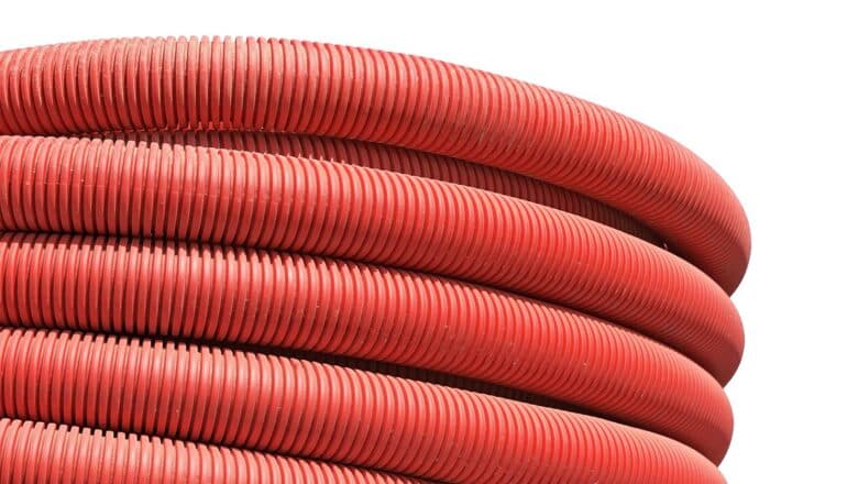 Red tubes piled on each other against a white background.