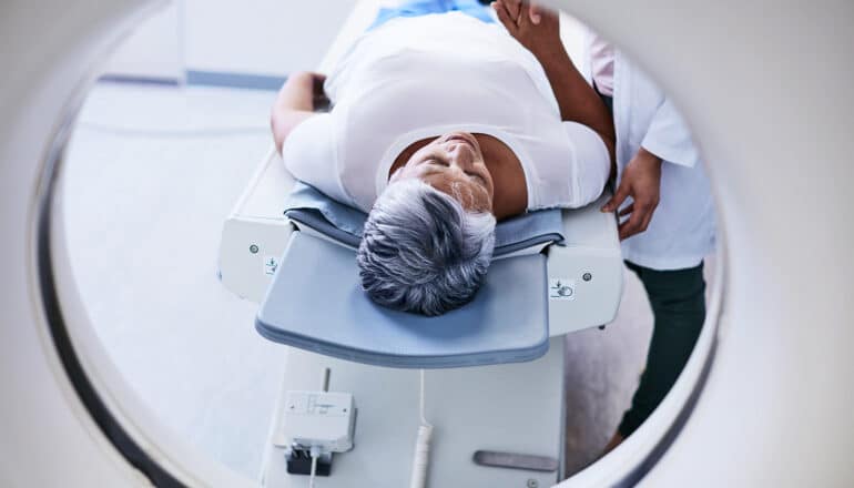 A woman lays down for an MRI.