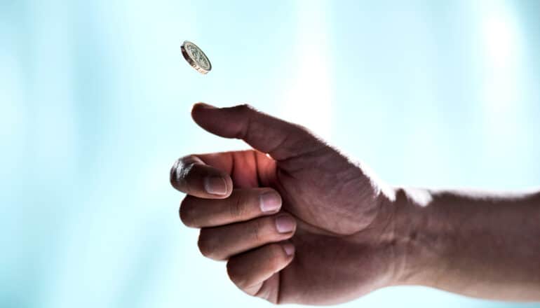 A person flips a coin.