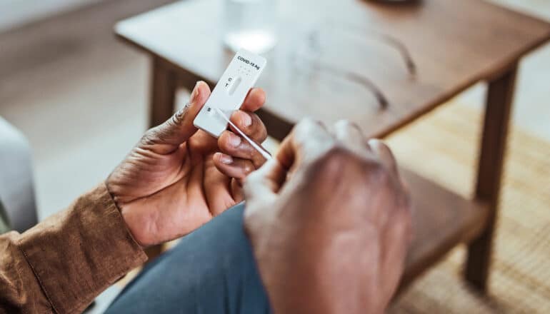 A man uses an at-home rapid Covid test.